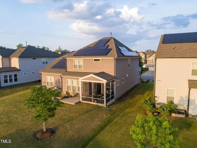 428 Parlier Dr, Apex, NC 27523 - back of house with a lawn, solar panels, a shingled roof, and a sunroom