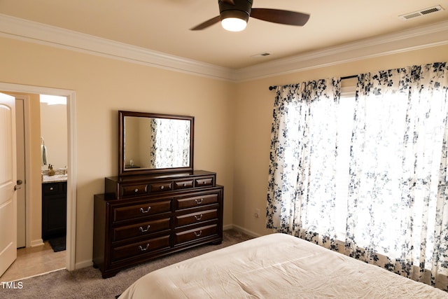 428 Parlier Dr, Apex, NC 27523 - carpeted bedroom featuring crown molding, ceiling fan, baseboards, ensuite bathroom, and visible vents