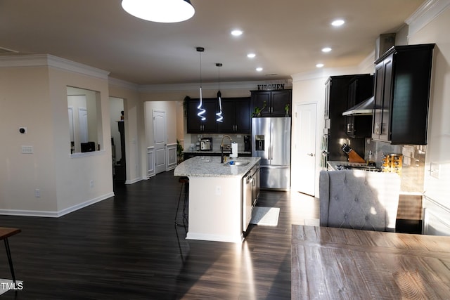 428 Parlier Dr, Apex, NC 27523 - kitchen featuring under cabinet range hood, tasteful backsplash, dark cabinets, a sink, and stainless steel appliances