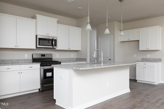 kitchen with a kitchen island with sink, dark wood-type flooring, stainless steel appliances, and white cabinets