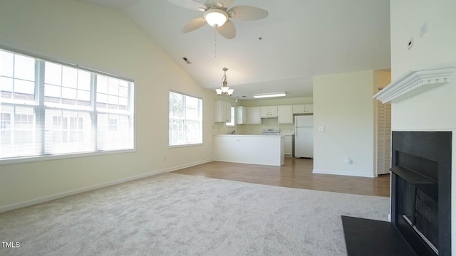4024 Claret Ln, Morrisville, NC 27560 - unfurnished living room with baseboards, carpet flooring, a multi sided fireplace, ceiling fan with notable chandelier, and vaulted ceiling