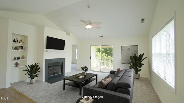4024 Claret Ln, Morrisville, NC 27560 - living room featuring ceiling fan, visible vents, a fireplace with flush hearth, vaulted ceiling, and carpet flooring