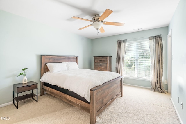 bedroom featuring light carpet, baseboards, and ceiling fan