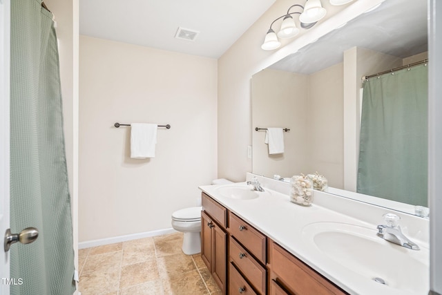 full bath with toilet, baseboards, and double vanity