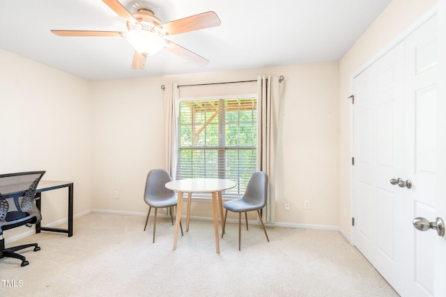 office area with light colored carpet, baseboards, and ceiling fan