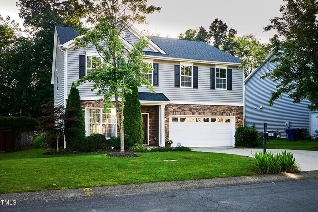 5031 Mckittrick Ln, Durham, NC 27712 - view of front of house with stone siding, an attached garage, concrete driveway, and a front yard