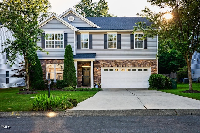 5031 Mckittrick Ln, Durham, NC 27712 - view of front of home with driveway, a front yard, a garage, and stone siding