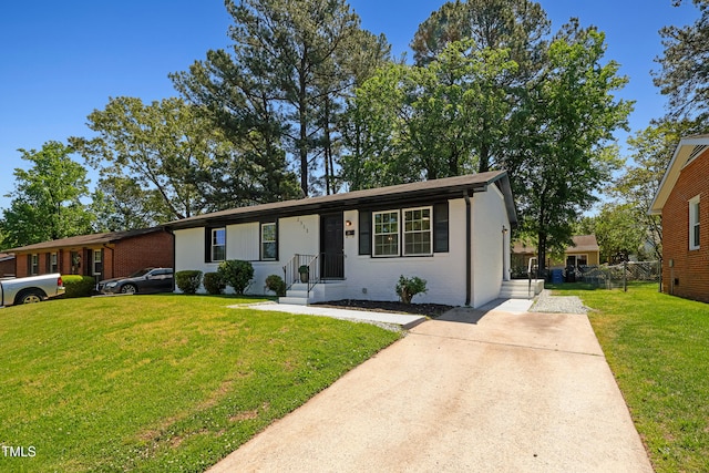 2311 Wintergreen Pl, Durham, NC 27707 - single story home featuring concrete driveway, brick siding, fence, and a front yard