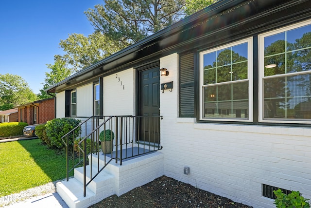 2311 Wintergreen Pl, Durham, NC 27707 - view of exterior entry with a lawn and crawl space