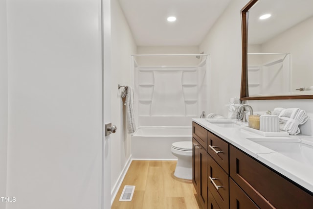 2311 Wintergreen Pl, Durham, NC 27707 - bathroom featuring visible vents, double vanity, wood finished floors, recessed lighting, and a sink