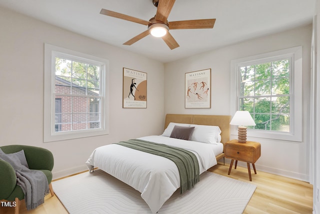 2311 Wintergreen Pl, Durham, NC 27707 - bedroom with ceiling fan, baseboards, multiple windows, and wood finished floors