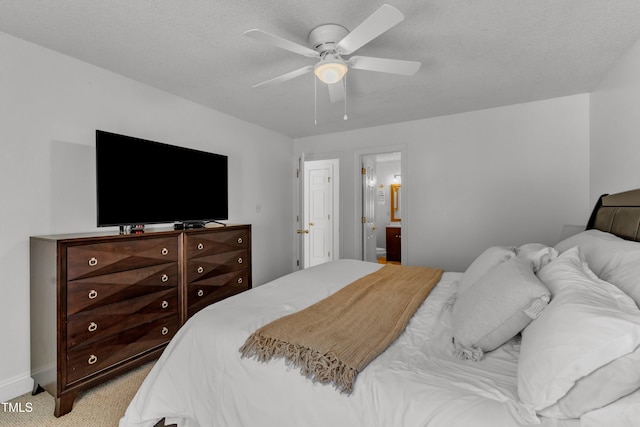 bedroom with light colored carpet, ceiling fan, ensuite bathroom, and baseboards