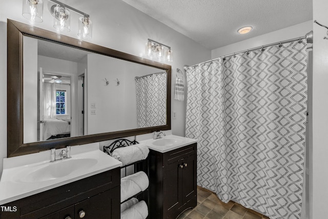 full bathroom featuring ensuite bathroom, a textured ceiling, and vanity