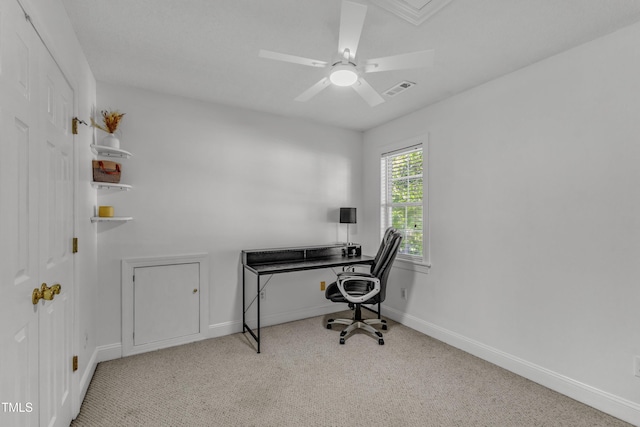 carpeted office space with baseboards and a ceiling fan