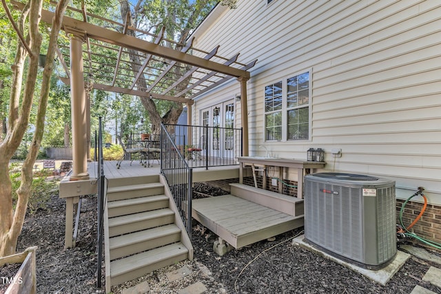 wooden deck with central AC unit, a pergola, and stairway