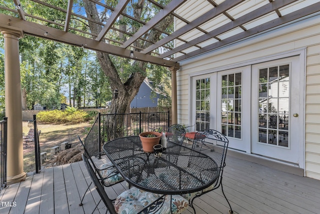 deck with a pergola, fence, and outdoor dining area