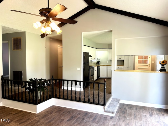 interior space with beamed ceiling, ceiling fan, visible vents, and dark wood finished floors