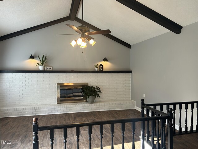 stairs featuring vaulted ceiling with beams, a ceiling fan, and wood finished floors
