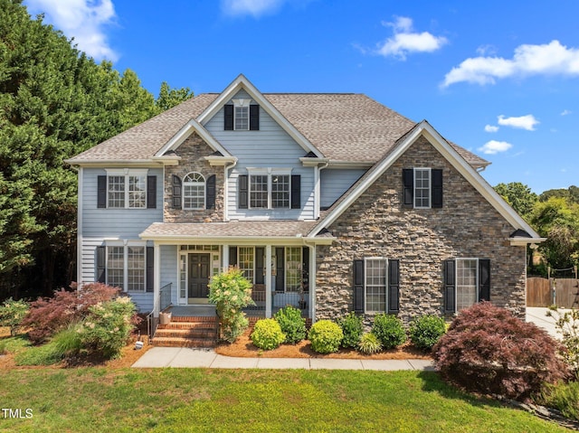 1420 Norwood Crest Ct, Raleigh, NC 27614 - view of front of property with a porch, a front yard, stone siding, and roof with shingles