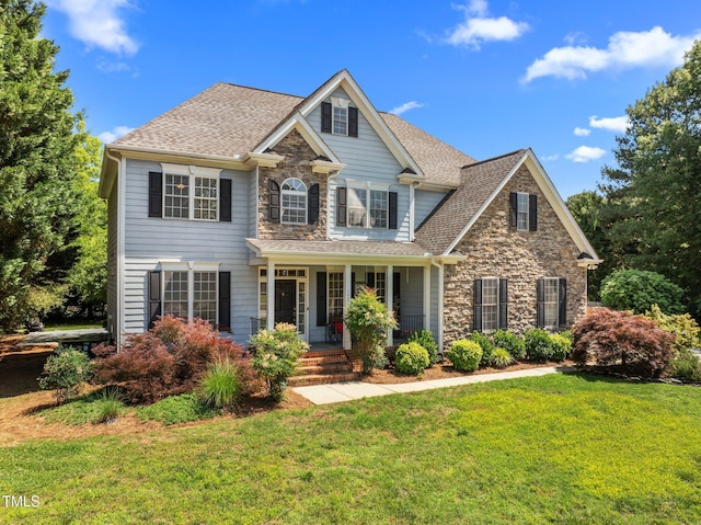 1420 Norwood Crest Ct, Raleigh, NC 27614 - view of front of property with covered porch, stone siding, a front lawn, and roof with shingles