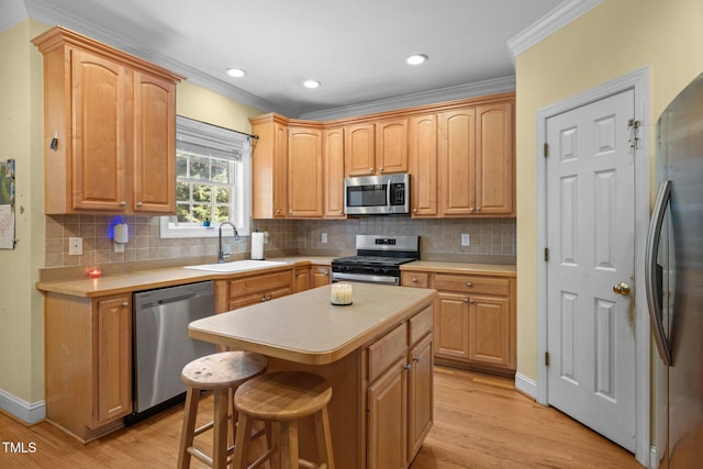 1420 Norwood Crest Ct, Raleigh, NC 27614 - kitchen featuring appliances with stainless steel finishes, ornamental molding, a sink, light wood-type flooring, and light countertops