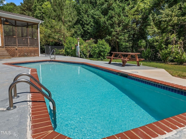 1420 Norwood Crest Ct, Raleigh, NC 27614 - outdoor pool featuring a sunroom, a patio area, and view of wooded area