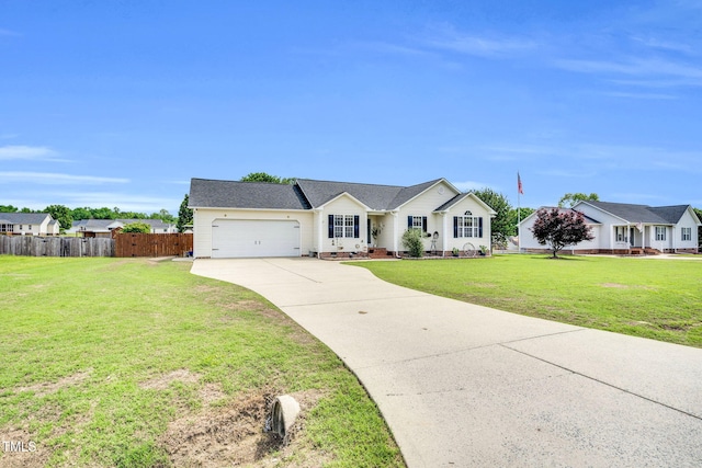 ranch-style home with fence, an attached garage, driveway, and a front yard