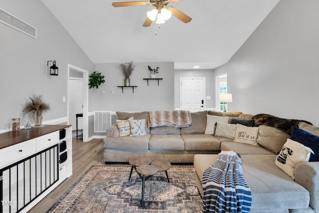 living room with a ceiling fan, recessed lighting, wood finished floors, lofted ceiling, and visible vents