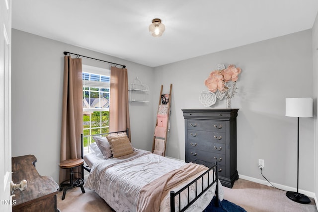 bedroom featuring baseboards and light carpet