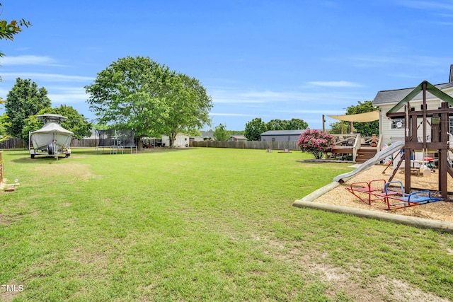 view of yard featuring a playground, a fenced backyard, a trampoline, and a shed