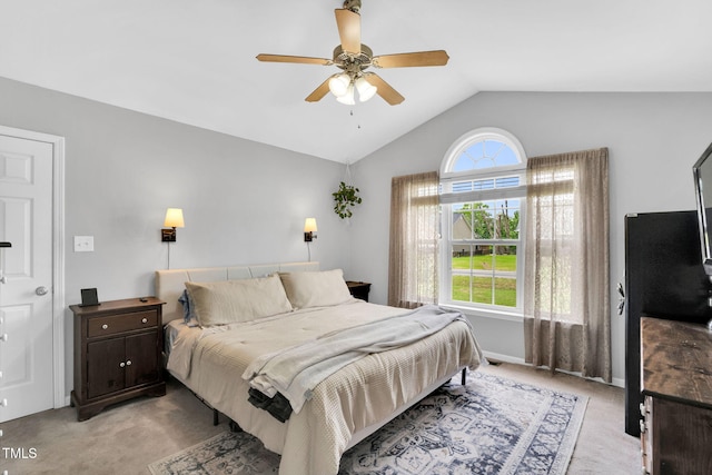 bedroom featuring ceiling fan, light colored carpet, and vaulted ceiling