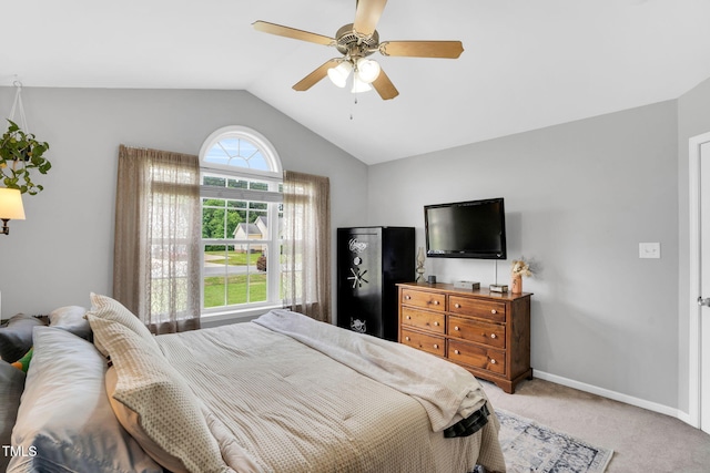 bedroom with a ceiling fan, baseboards, light carpet, and lofted ceiling