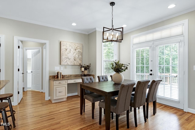 dining space with crown molding, recessed lighting, light wood-style flooring, and a chandelier