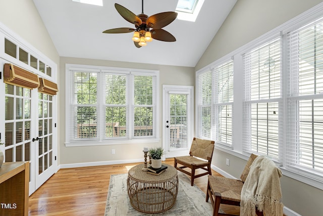 sunroom / solarium with a skylight, a healthy amount of sunlight, and french doors