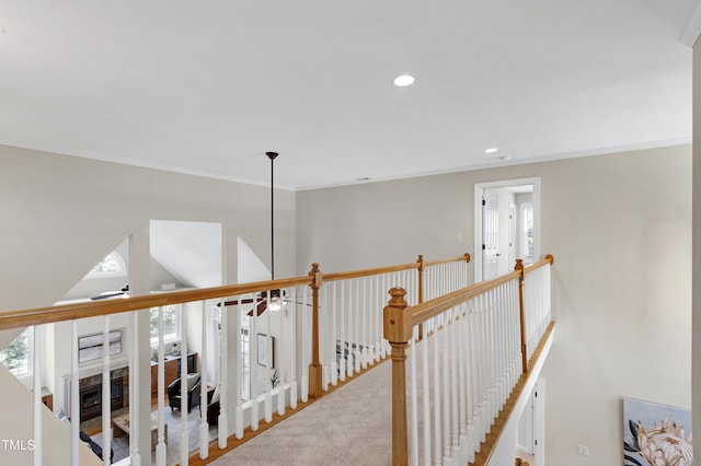 hallway featuring recessed lighting, an upstairs landing, ornamental molding, and a wealth of natural light