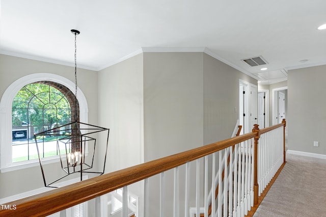 hall with light colored carpet, a notable chandelier, baseboards, an upstairs landing, and visible vents