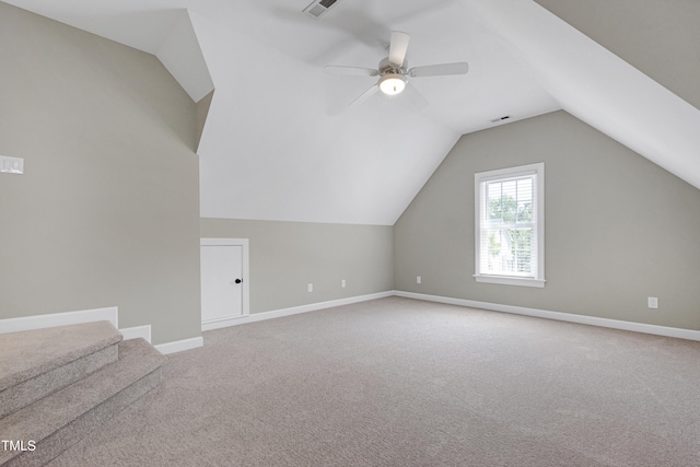 additional living space with baseboards, a ceiling fan, carpet, and lofted ceiling