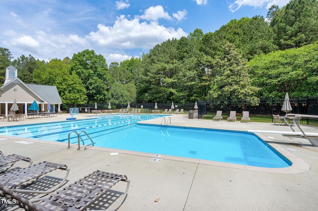 pool featuring a patio and fence