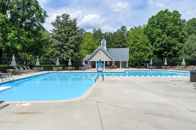 community pool featuring a patio and fence