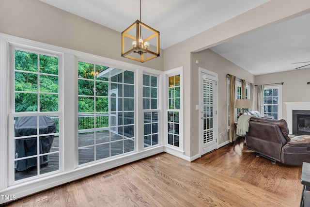 1001 Dairy House Ct, Wake Forest, NC 27587 - entryway featuring a chandelier, wood finished floors, a glass covered fireplace, and baseboards