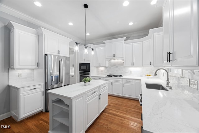 kitchen featuring a kitchen island, stainless steel appliances, white cabinets, and a sink