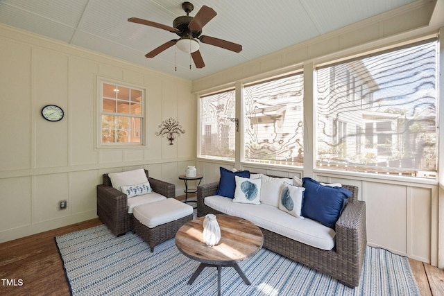 sunroom / solarium featuring a ceiling fan and an outdoor hangout area