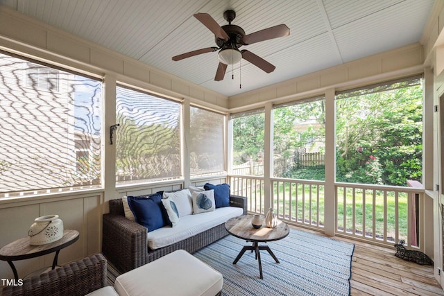 sunroom with ceiling fan, an outdoor hangout area, and a wealth of natural light