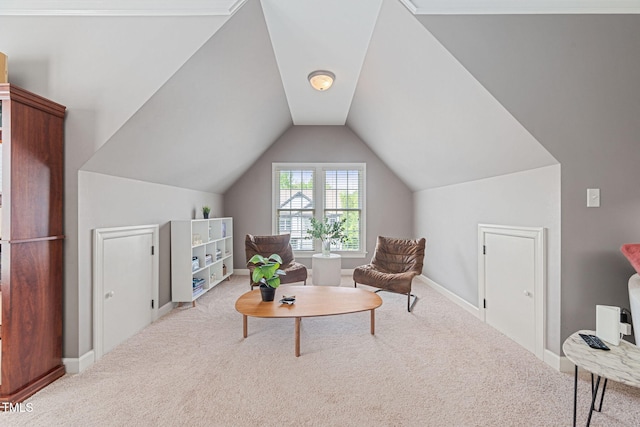 living area featuring baseboards, carpet, and lofted ceiling