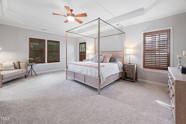 bedroom featuring crown molding, baseboards, ceiling fan, a raised ceiling, and carpet flooring