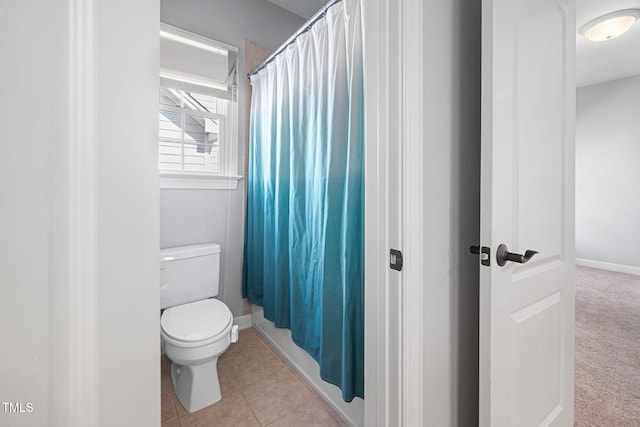 bathroom with tile patterned floors, baseboards, toilet, and a shower with shower curtain