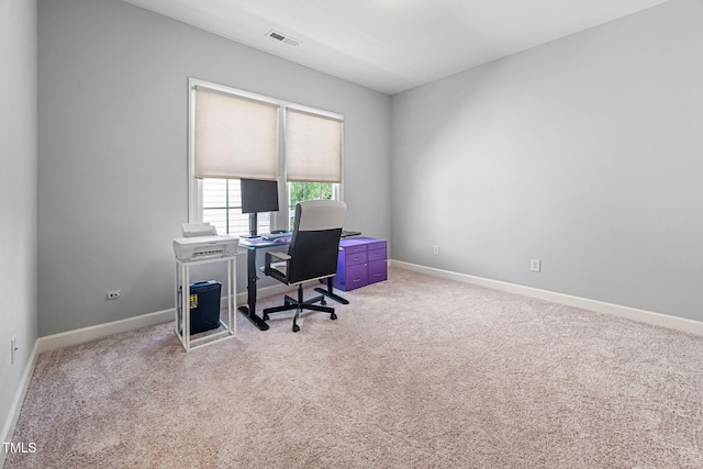 carpeted office space with baseboards and visible vents