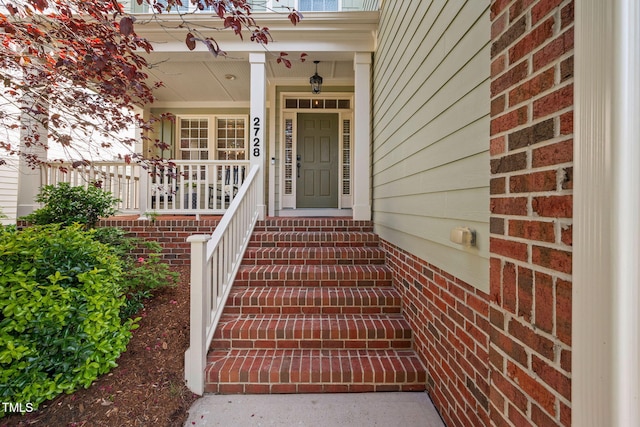 doorway to property featuring a porch