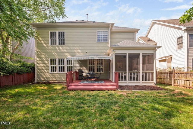 rear view of property with a shingled roof, a sunroom, a deck, a fenced backyard, and a lawn