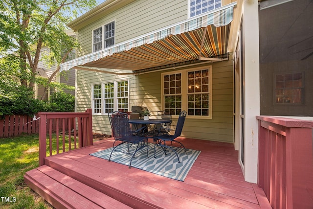 deck featuring fence and outdoor dining space